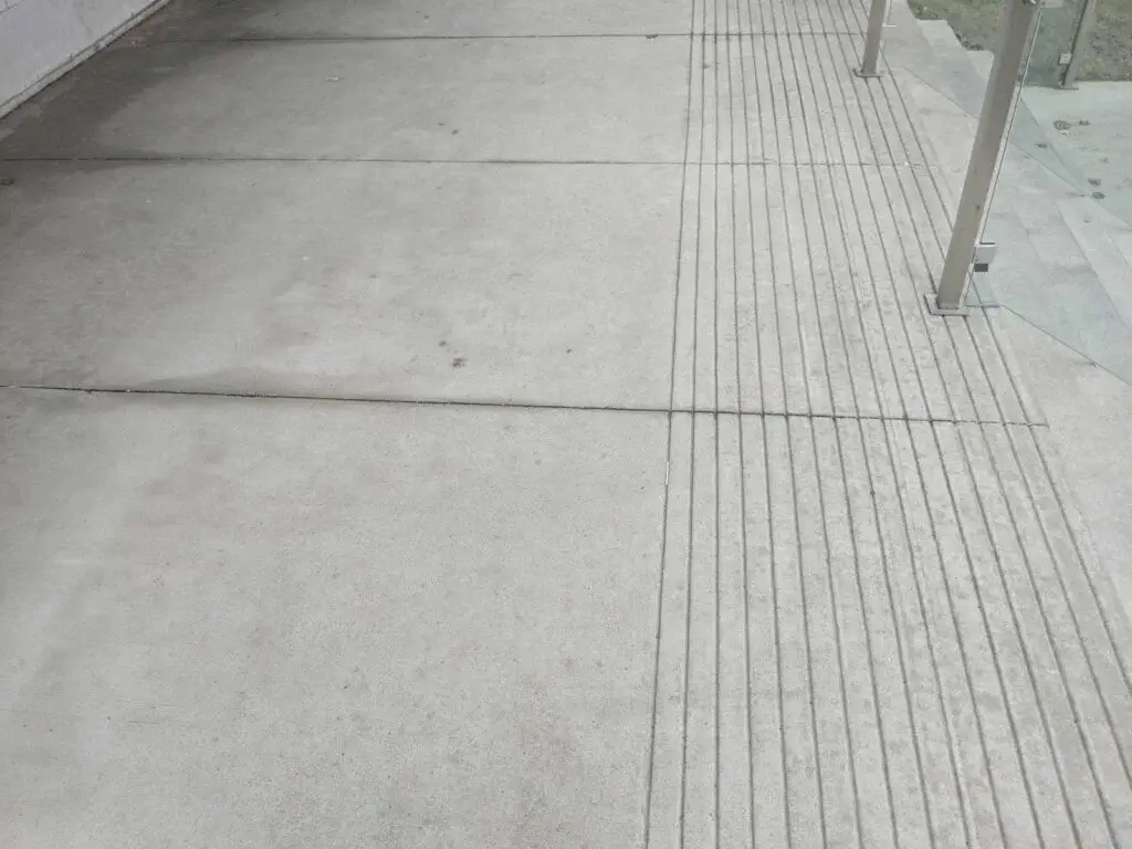 Commercial concrete floor cleaning at a Chicago business entrance, serviced by Carpet Cleaning Group