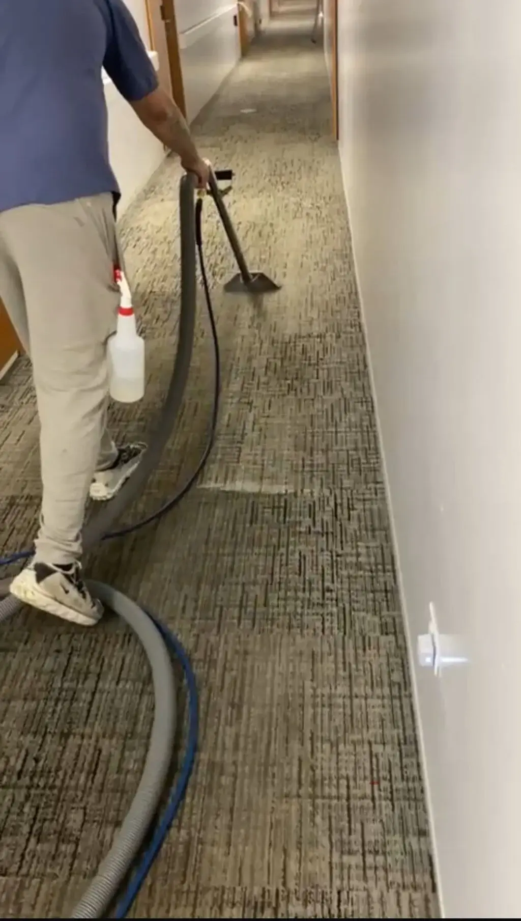 Carpet Cleaning Group technician steam cleaning a commercial hallway carpet in a Chicago office building