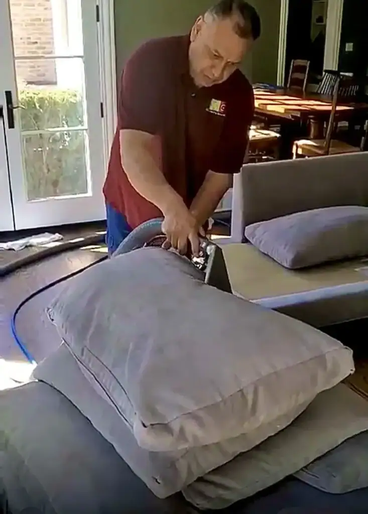 Carpet Cleaning Group technician deep cleaning sofa cushions in a Chicago home using professional upholstery equipment