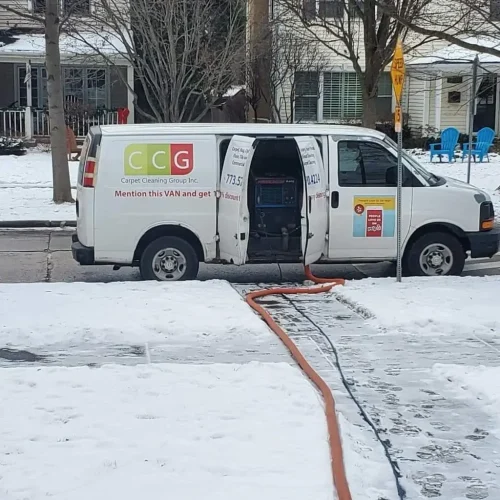 Carpet Cleaning Group branded service van on a job in a Chicago neighborhood during winter