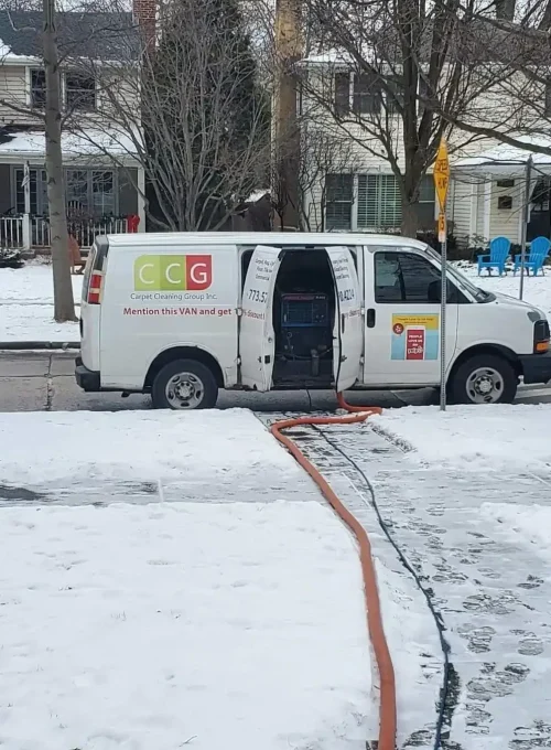 Carpet Cleaning Group branded service van on a job in a Chicago neighborhood during winter