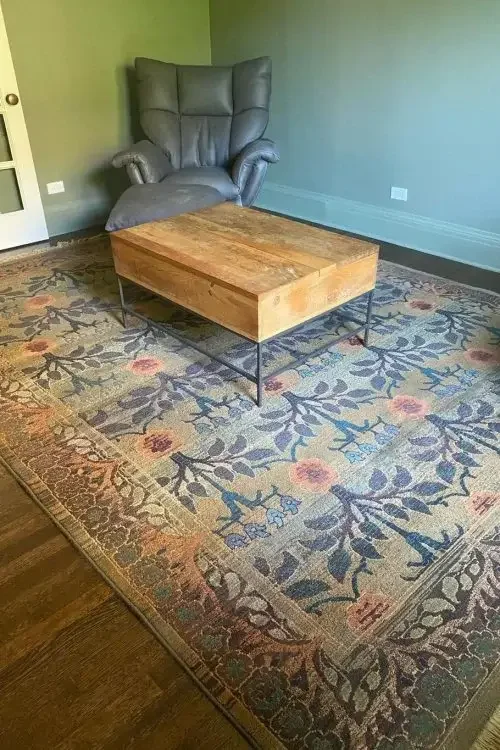 Professionally cleaned floral area rug in a Chicago home living room, restored by Carpet Cleaning Group