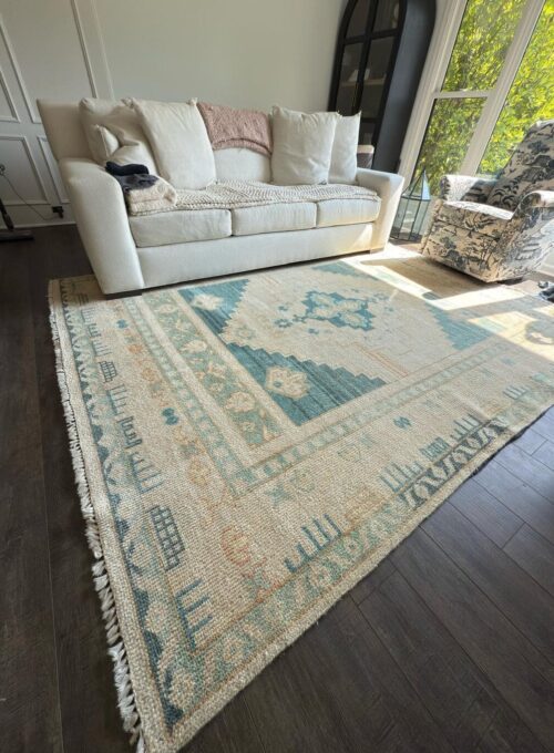 Professionally cleaned teal geometric fringed area rug in a Chicago home living room by Carpet Cleaning Group