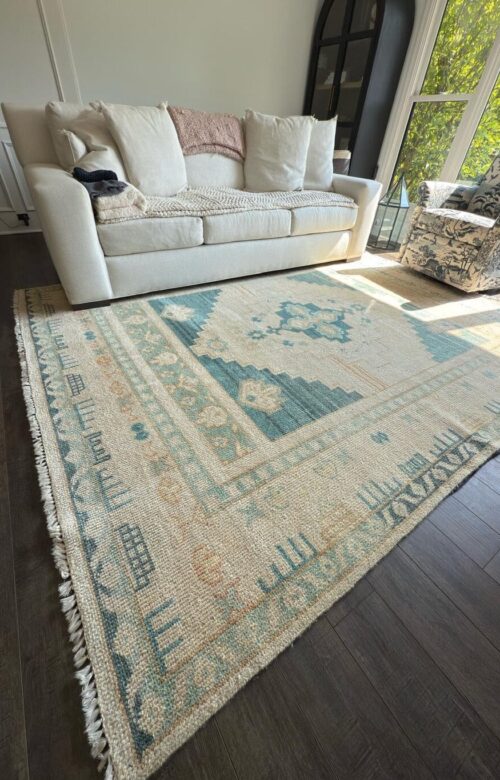 Professionally cleaned teal geometric fringed area rug in a Chicago home living room by Carpet Cleaning Group