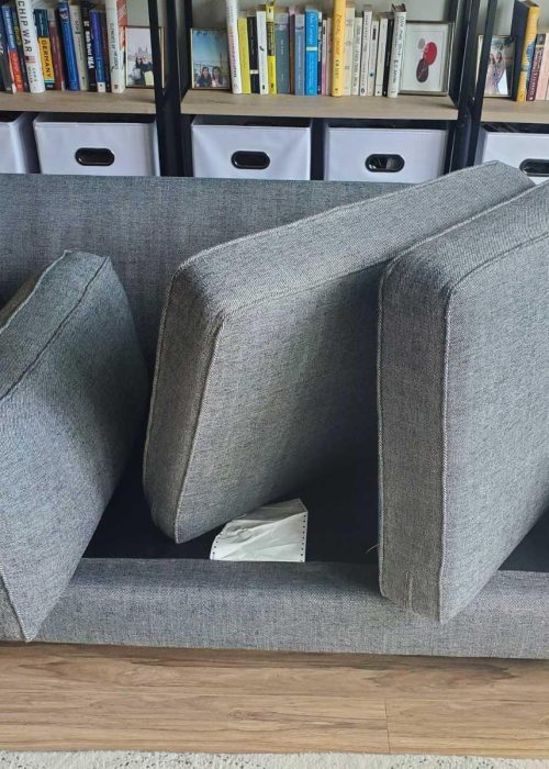 Gray fabric sofa with cushions removed for deep upholstery cleaning service in a Chicago home